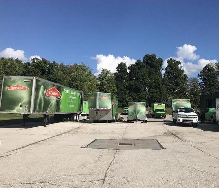 Several green SERVPRO Trailers in a parking lot